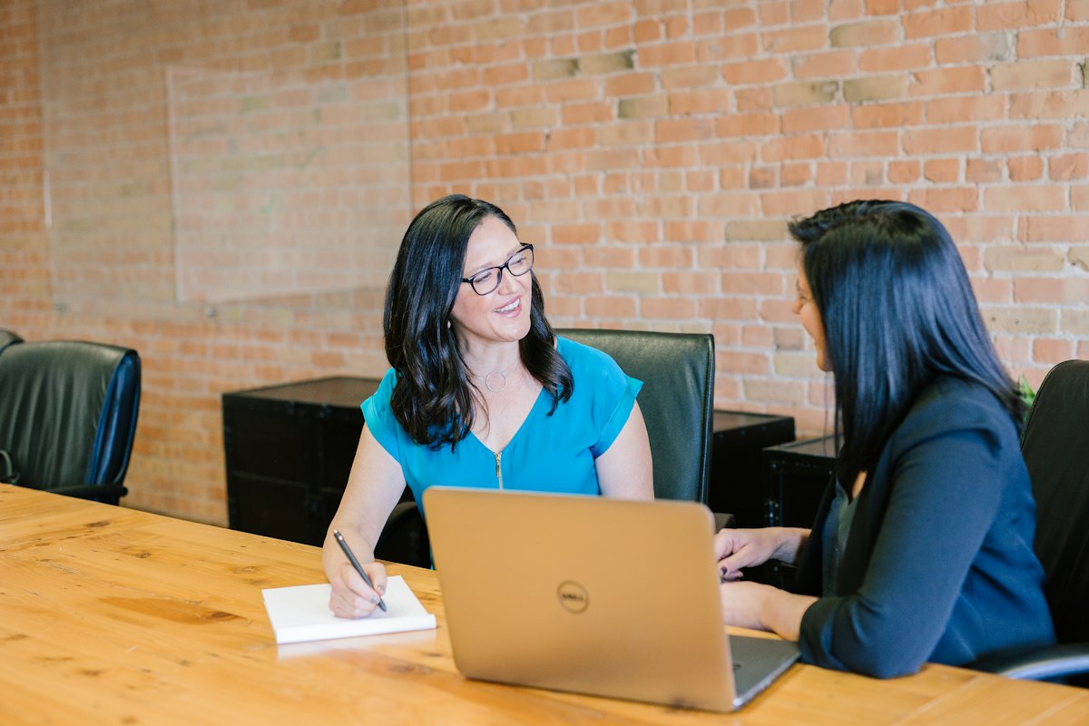 A loan officer working through a file with a borrower across the table